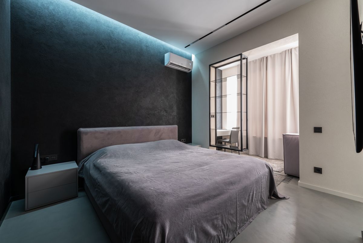 Bedroom with a bed and a split air conditioner on the wall